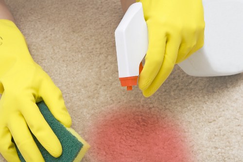 Carpet cleaner working safely with protective equipment in a St Pauls Cray home