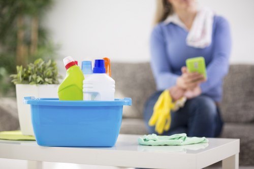 Cleaner wearing PPE while carrying out carpet cleaning in a property